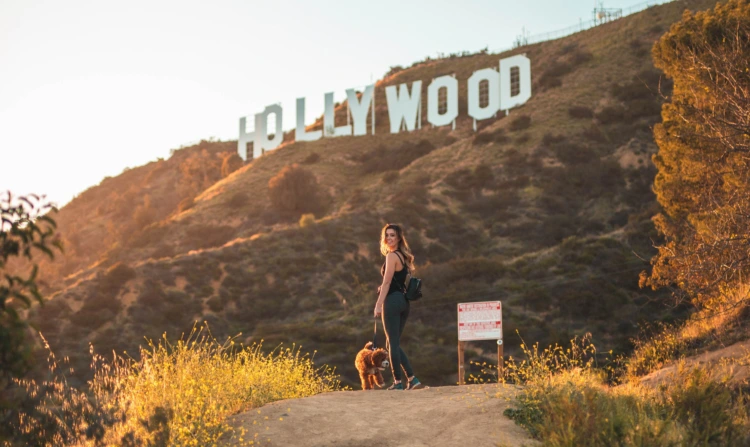Woman walking with her ESA underneath the Hollywood sign in Los Angeles, California